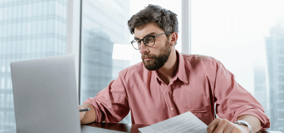 man in pink shirt working